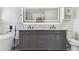 The bathroom has dual sinks and a built-in vanity with a decorative mirror at 4604 9Th E Ave, Bradenton, FL 34208