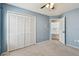 Bedroom with blue accent wall, plush carpet, and a closet with louvered doors at 4604 9Th E Ave, Bradenton, FL 34208
