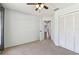 Bedroom featuring neutral carpet, modern ceiling fan, and closet with louvered doors at 4604 9Th E Ave, Bradenton, FL 34208