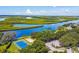The community features scenic waterfront views, lush greenery, a tennis court, and volleyball area at 4604 9Th E Ave, Bradenton, FL 34208
