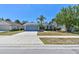 Charming single-story home with a well-maintained lawn, palm trees, and a two-car garage at 4604 9Th E Ave, Bradenton, FL 34208