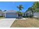 Charming single-story home with a well-maintained lawn, palm trees, and a two-car garage at 4604 9Th E Ave, Bradenton, FL 34208