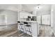 Open kitchen with breakfast bar, stainless steel appliances, and modern cabinetry at 4604 9Th E Ave, Bradenton, FL 34208