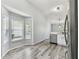Bright kitchen area with stainless steel appliances, a bay window, and wood-look floors at 4604 9Th E Ave, Bradenton, FL 34208
