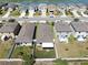 An aerial view displays houses and lawns in a residential neighborhood near a pond at 4722 Lindever Ln, Palmetto, FL 34221