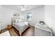 Bright bedroom with wood floors, ceiling fan, a large window and coastal decor at 4722 Lindever Ln, Palmetto, FL 34221
