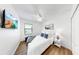 Cozy bedroom features wood floors, ceiling fan, a large window, and wall mounted television at 4722 Lindever Ln, Palmetto, FL 34221