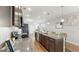 Spacious kitchen with granite countertops, stainless steel appliances, an island with bar seating, and wooden floors at 4722 Lindever Ln, Palmetto, FL 34221