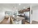 Modern kitchen features stainless steel appliances, an island with bar stools, and an adjacent living area at 4722 Lindever Ln, Palmetto, FL 34221