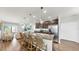 Charming kitchen island with stainless steel appliances, pendant lighting, bar stools, and an adjacent living area at 4722 Lindever Ln, Palmetto, FL 34221