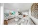 Open living room features stylish decor, light walls, modern furniture, and seamless flow to the kitchen at 4722 Lindever Ln, Palmetto, FL 34221