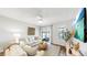 Bright living room features neutral decor, hardwood floors, and sliding glass doors to outdoor patio at 4722 Lindever Ln, Palmetto, FL 34221