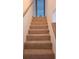Carpeted staircase with wooden handrails leading to the upper level of the home at 4941 25Th W St # 101, Bradenton, FL 34207