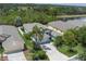 Aerial view of property with mature trees and bushes surrounding the building and a large pond at 5209 Lansdowne Way, Palmetto, FL 34221