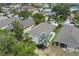 Expansive aerial shot showcases the home's backyard and screened in lanai in a lush, green neighborhood at 5209 Lansdowne Way, Palmetto, FL 34221
