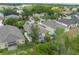 Expansive aerial shot showcases the home's backyard and screened in lanai in a lush, green neighborhood at 5209 Lansdowne Way, Palmetto, FL 34221