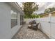 Paver patio with outdoor seating and grill surrounded by a white vinyl privacy fence at 5209 Lansdowne Way, Palmetto, FL 34221