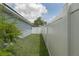 Backyard with well-maintained lawn and white vinyl fence bordering the property at 5209 Lansdowne Way, Palmetto, FL 34221
