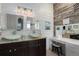 Unique primary bathroom with double vanity, wood accent wall, a makeup vanity, and decorative sinks at 5209 Lansdowne Way, Palmetto, FL 34221