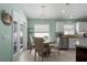 Bright dining area with a round table, chairs, and a view to the backyard through sliding glass doors at 5209 Lansdowne Way, Palmetto, FL 34221