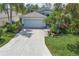 Charming single-Gathering home with a gray garage, complemented by lush landscaping and a welcoming driveway at 5209 Lansdowne Way, Palmetto, FL 34221