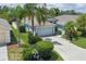 Charming single-Gathering home with a gray garage, complemented by lush landscaping and a welcoming driveway at 5209 Lansdowne Way, Palmetto, FL 34221
