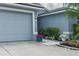 Well-maintained home featuring a two-car garage, professional landscaping, and a walkway to the front entrance at 5209 Lansdowne Way, Palmetto, FL 34221