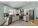 Modern kitchen featuring white cabinets, stainless steel appliances, and a stylish backsplash at 5209 Lansdowne Way, Palmetto, FL 34221