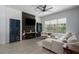 Bright and airy living room with tile flooring, a sectional sofa, and a large window overlooking the yard at 5209 Lansdowne Way, Palmetto, FL 34221