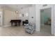 Open living space with tiled floors, a patterned chair, and a glimpse into an adjacent room at 5209 Lansdowne Way, Palmetto, FL 34221