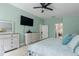Spacious main bedroom featuring light green walls, wood floors, and dressers with an ensuite bath access at 5209 Lansdowne Way, Palmetto, FL 34221