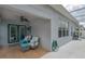 Covered patio boasts comfortable outdoor seating, ceiling fan and access to the backyard at 5209 Lansdowne Way, Palmetto, FL 34221