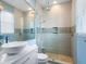 Modern bathroom with a vessel sink, large shower with dual shower heads, and neutral tile at 521 Habitat Blvd, Osprey, FL 34229