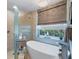 Bathroom featuring a standalone tub and walk in shower at 521 Habitat Blvd, Osprey, FL 34229