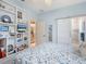 Cozy bedroom featuring a custom shelving unit and an ensuite bathroom with barn door entry at 521 Habitat Blvd, Osprey, FL 34229