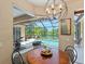 Breakfast nook with views of the pool and lake features a round table with seating for casual dining at 521 Habitat Blvd, Osprey, FL 34229
