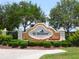 Community entrance sign framed by lush greenery and landscaping, showcasing the neighborhood's welcoming atmosphere at 521 Habitat Blvd, Osprey, FL 34229