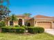 Charming home featuring a well-maintained lawn, manicured shrubs, and a clay tile roof, offering great curb appeal at 521 Habitat Blvd, Osprey, FL 34229