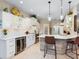 Modern kitchen with white cabinets, quartz countertops, stainless steel appliances, and a stylish center island with bar seating at 521 Habitat Blvd, Osprey, FL 34229