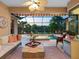 Relaxing lanai with a seating area, ceiling fan, and views of the pool and backyard at 521 Habitat Blvd, Osprey, FL 34229