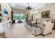 Bright living room featuring an electric fireplace, entertainment center, and views of the lanai at 521 Habitat Blvd, Osprey, FL 34229