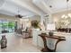 Spacious living area with views of the pool, decorative columns, and tile flooring at 521 Habitat Blvd, Osprey, FL 34229