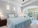 A cozy bedroom with sitting area and plenty of natural light at 521 Habitat Blvd, Osprey, FL 34229