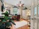 Home office features a ceiling fan, natural light, and dark wood floors and an accent fish theme at 521 Habitat Blvd, Osprey, FL 34229