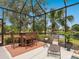 Outdoor seating on the screened in patio with lake view at 521 Habitat Blvd, Osprey, FL 34229