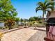 A serene outdoor patio overlooking a peaceful lake at 521 Habitat Blvd, Osprey, FL 34229