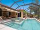 Screened-in pool area with a hot tub, outdoor seating, and lush landscaping offers a private oasis at 521 Habitat Blvd, Osprey, FL 34229