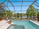 Gorgeous pool and spa area enclosed with a screen, offering lake views at 521 Habitat Blvd, Osprey, FL 34229