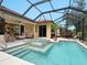 Relaxing screened in pool with jacuzzi and a view of the Gathering room at 521 Habitat Blvd, Osprey, FL 34229