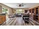 A comfortable living room with lots of natural light, wood floors, and an entertainment center at 5705 9Th Ave Dr W, Bradenton, FL 34209